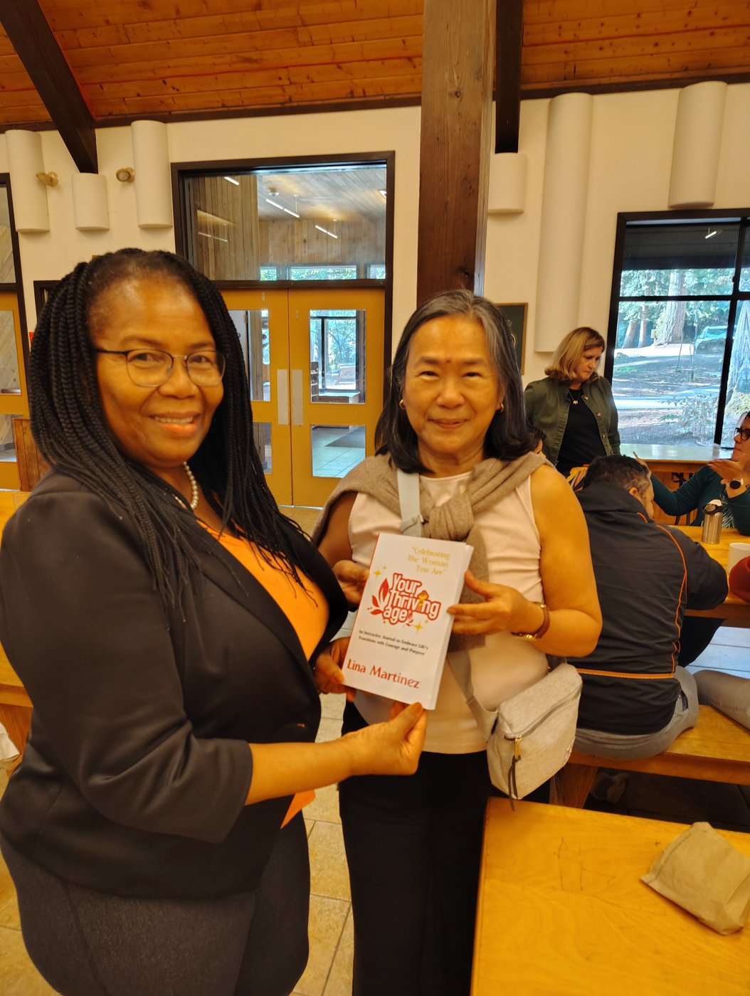 Lina Martinez with a reader holding her book (3)