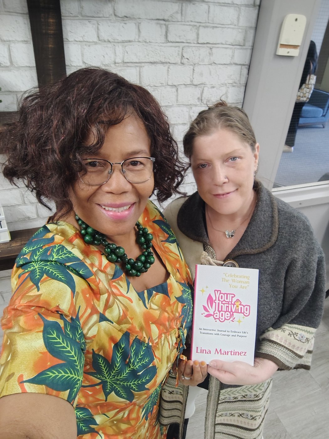 Lina Martinez with a reader holding her book (2)